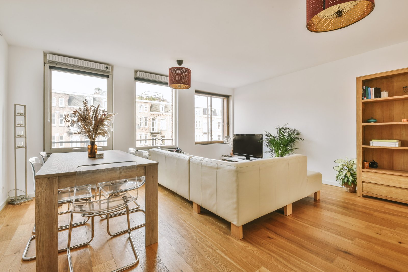 Square table placed on mat near couch and TV in stylish living room of contemporary apartment