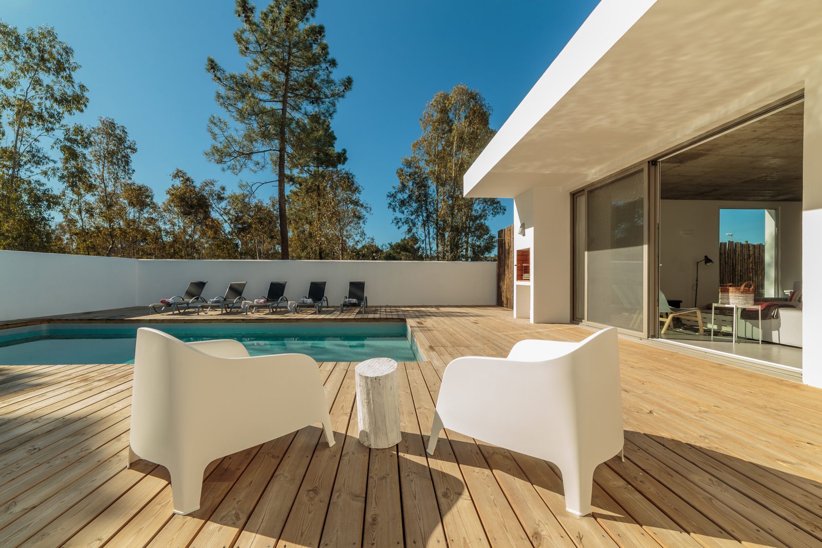 Modern house with garden swimming pool and wooden deck